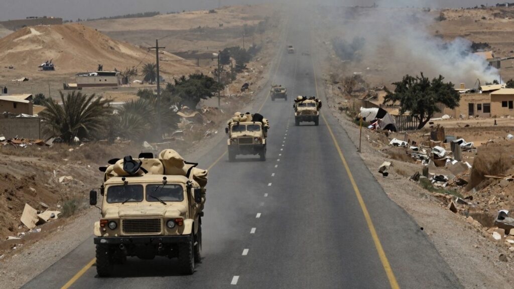Syrian highway with military vehicles and distant smoke.