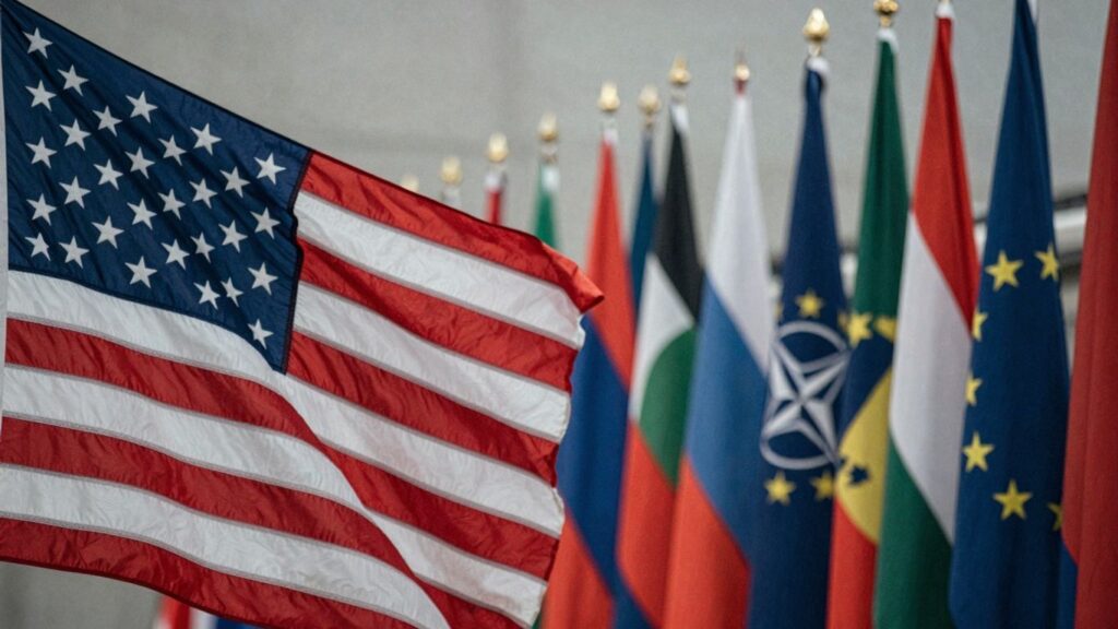 US flag and European/NATO flags with a focus shift.