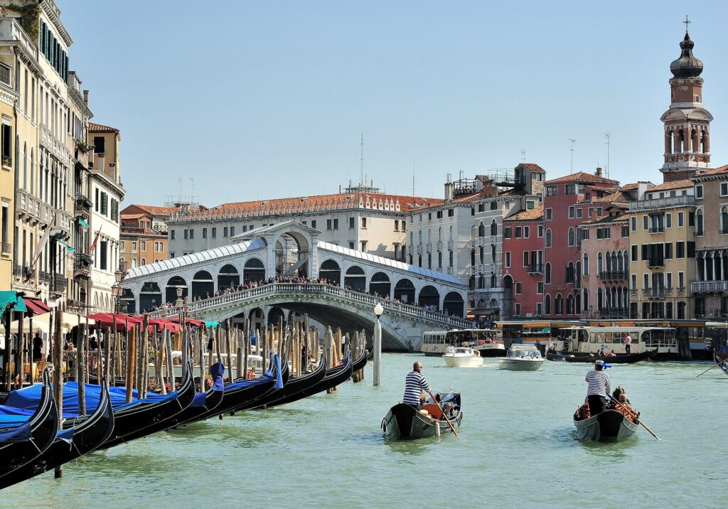 Gondolas and vaporetti on the busy Grand Canal near the Rialto Bridge in Venice