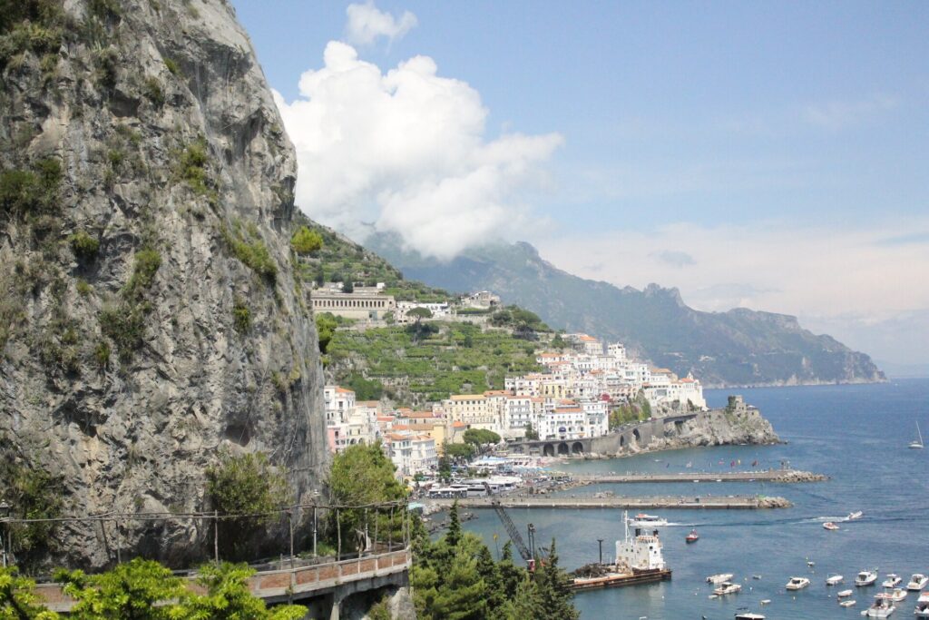 The Amalfi Coast road carved into the cliffs above the town and harbour of Amalfi