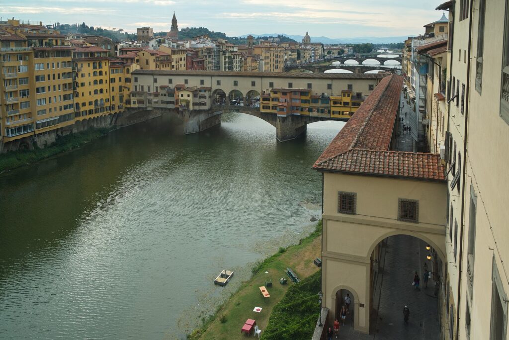 Uitzicht op de Ponte Vecchio, de Arno en de Vasari-corridor vanuit een raam van de Uffizi