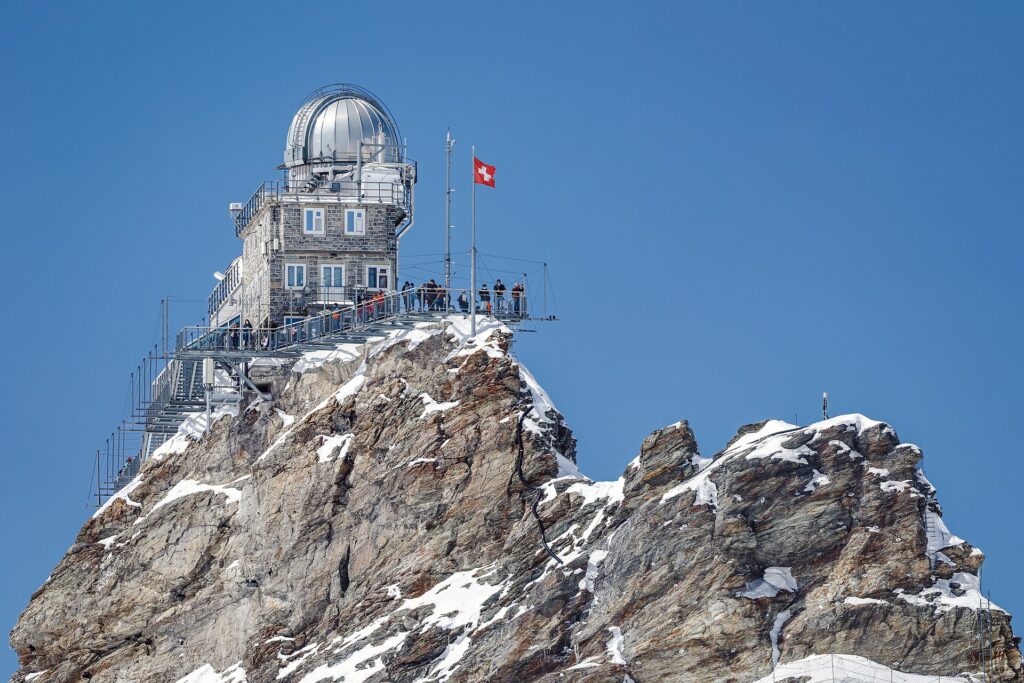 Sphinx Observatory on its rocky summit at Jungfraujoch under a blue sky