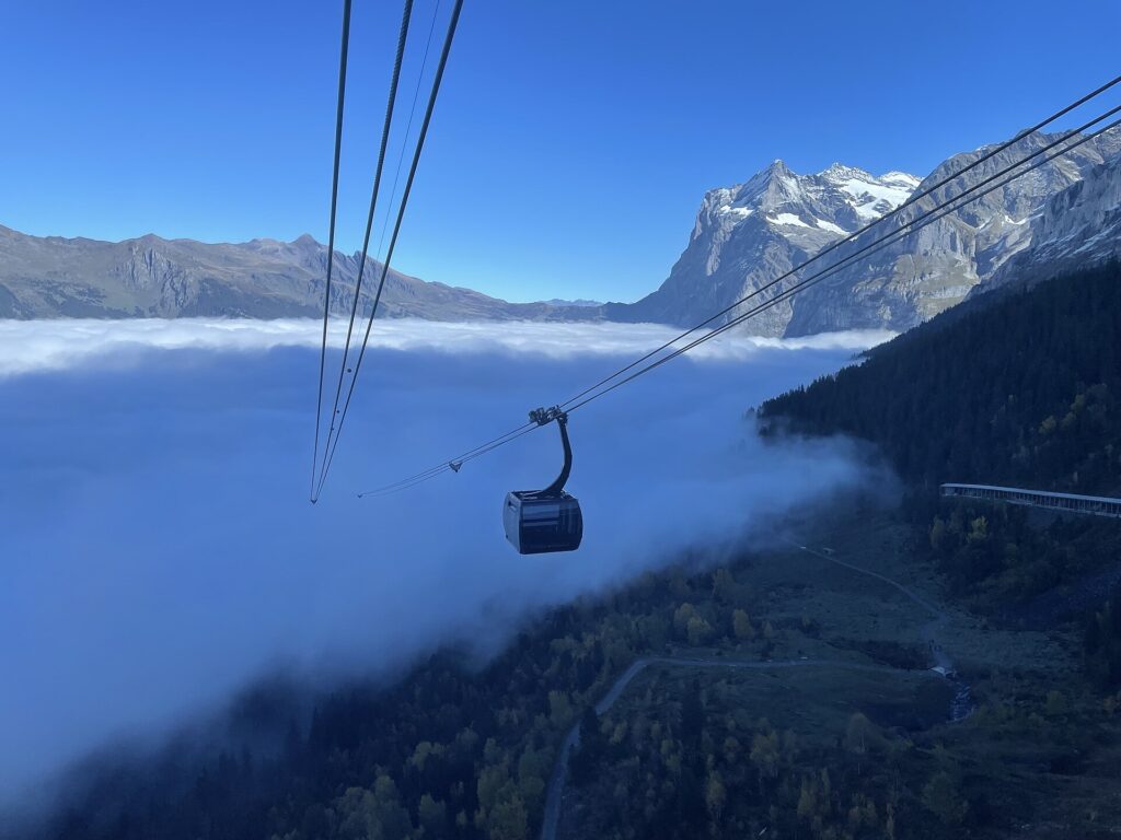 Eiger Express gondola above a sea of cloud near Grindelwald on the way to Jungfraujoch