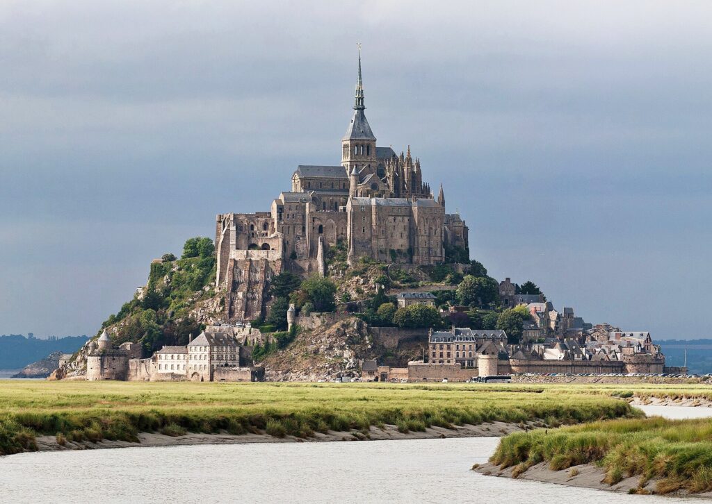 Mont-Saint-Michel and its abbey rising above the salt meadows of the bay