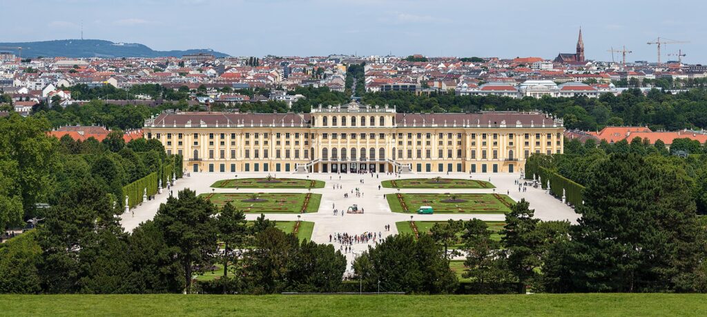 Schönbrunn Palace and its formal gardens seen from the Gloriette hill, with Vienna behind