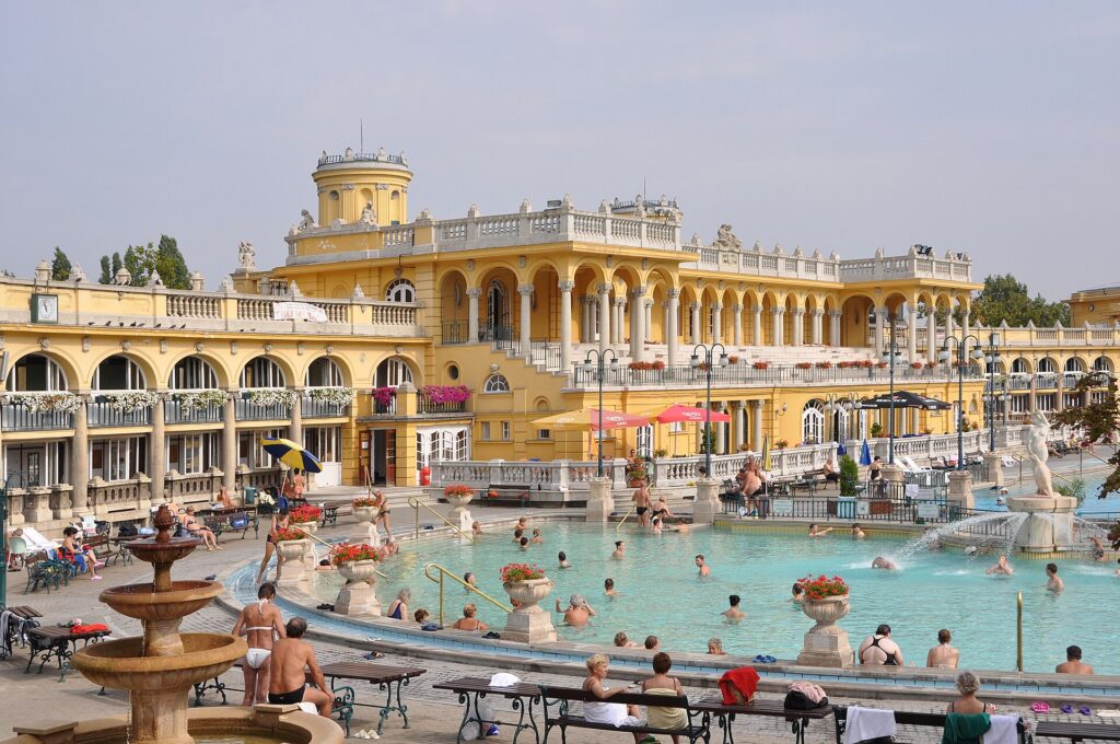Outdoor pools and yellow neo-Baroque buildings of the Széchenyi Thermal Bath in Budapest