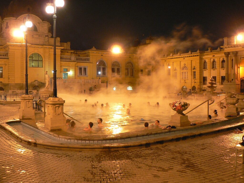Steam rising from the outdoor thermal pool at Széchenyi Bath in the evening