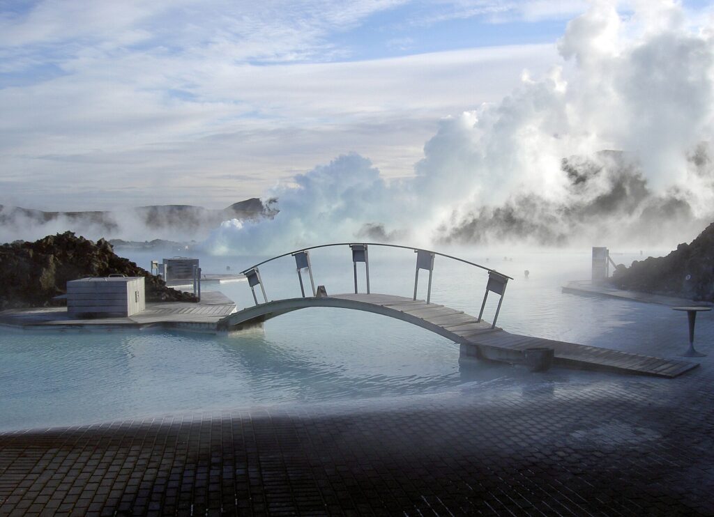 Wooden footbridge over the steaming water of the Blue Lagoon in Iceland