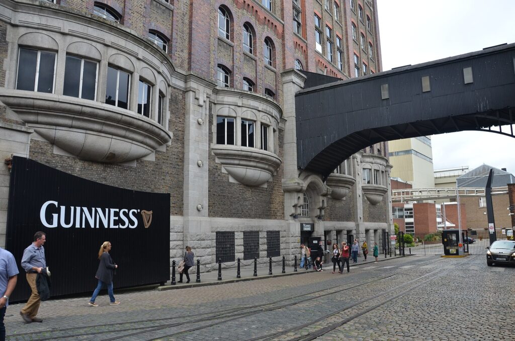 Entrance area of the Guinness Storehouse at St. James's Gate in Dublin with the Guinness sign and overhead walkway