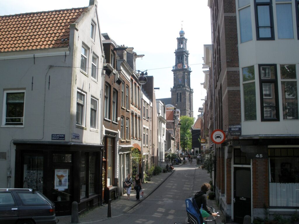 A quiet street in the Jordaan in Amsterdam with the Westerkerk tower in the background