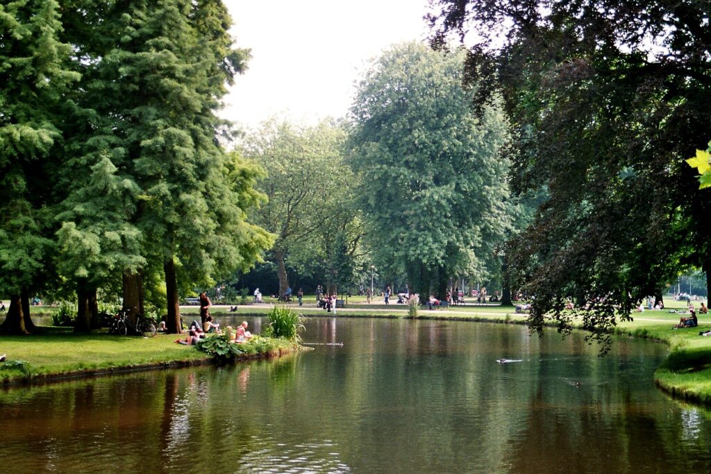 The pond in the Vondelpark in Amsterdam surrounded by trees and lawns