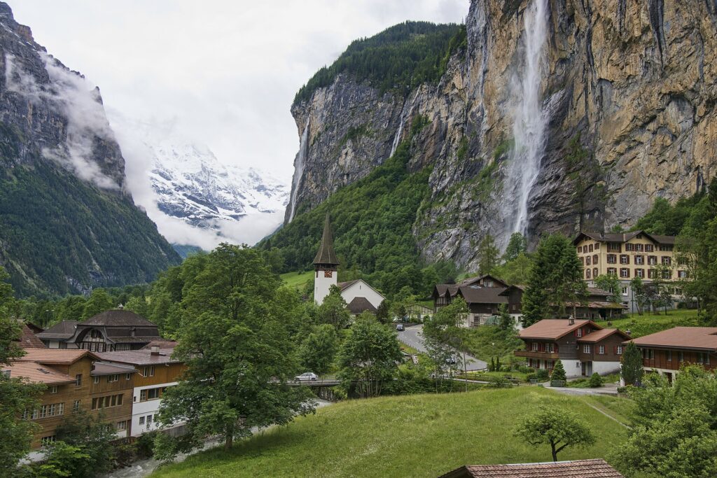 Staubbach Falls pouring down the cliff above the village of Lauterbrunnen